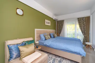 a bedroom with a blue bed and a couch at Sea&Center Lux in Bar