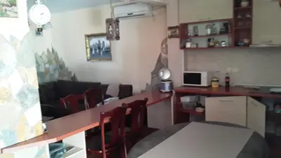 a room with a counter with chairs and a desk at Дом для семейного отдыха в Утехе, Черногория in Utjeha