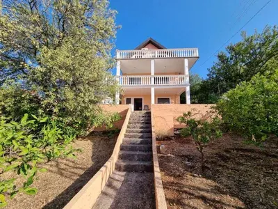 a house with a staircase leading up to it at Дом для семейного отдыха в Утехе, Черногория in Utjeha