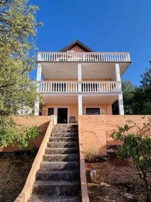 a house with stairs leading up to it at Дом для семейного отдыха в Утехе, Черногория in Utjeha