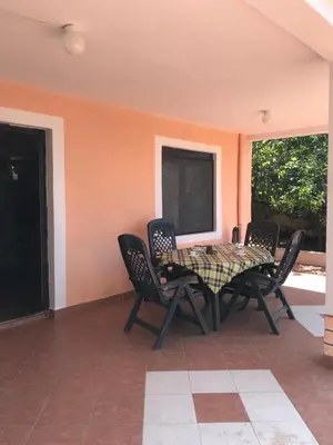 a table and chairs sitting on a patio at Дом для семейного отдыха в Утехе, Черногория in Utjeha