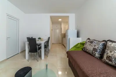 a living room with a couch and a table at Java Apartments in Dobrota