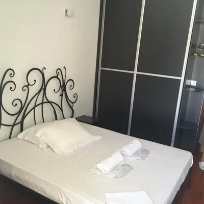 a bedroom with a bed with two towels on it at Apartments Vila Andja in Sveti Stefan