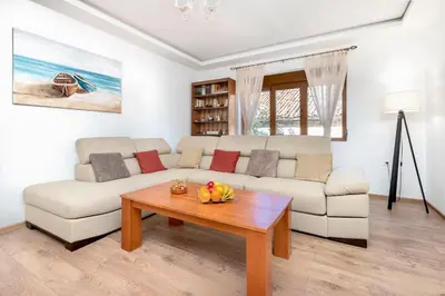 a living room with a white couch and a table at Seafoam apartment in Kotor