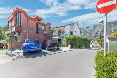 a street with two cars parked next to a building at Seafoam apartment in Kotor