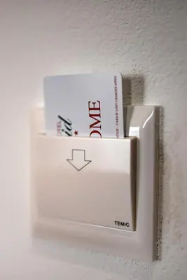 a white light switch with a book on it at David Lux beach rooms in Dobra Voda