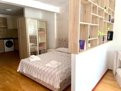 a bedroom with a bed and shelves in a room at Holiday apartments Petrovac in Petrovac na Moru