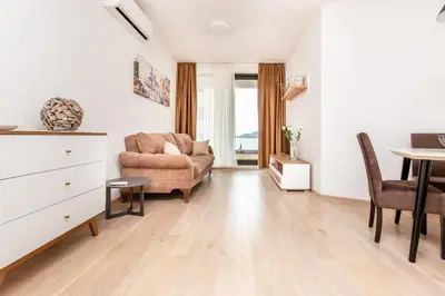 a living room with a couch and a table at Apartment with sea view BEATRICE#26 in Rafailovici