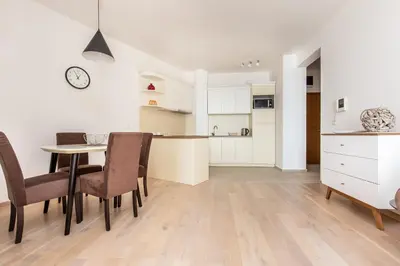 a kitchen and dining room with a table and chairs at Apartment with sea view BEATRICE#26 in Rafailovici