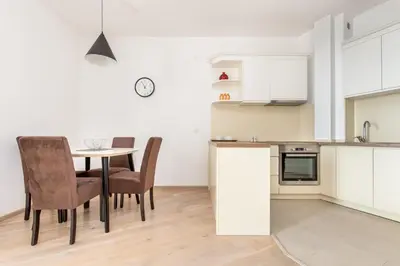a kitchen and dining room with a table and chairs at Apartment with sea view BEATRICE#26 in Rafailovici