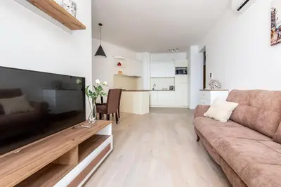 a living room with a couch and a table at Apartment with sea view BEATRICE#26 in Rafailovici