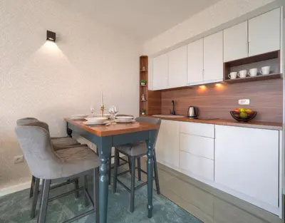 a kitchen with a table and chairs in a room at Garden Recovery in Sveti Stefan