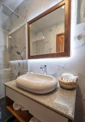 a bathroom with a sink and a mirror at Garden Recovery in Sveti Stefan