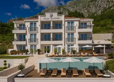 a hotel with a swimming pool and a resort at Garden Recovery in Sveti Stefan