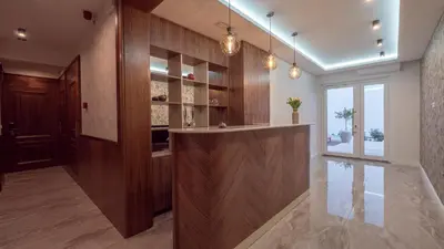 a large kitchen with a bar in the middle at Garden Recovery in Sveti Stefan