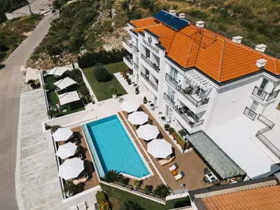 an aerial view of a building with a swimming pool at Garden Recovery in Sveti Stefan
