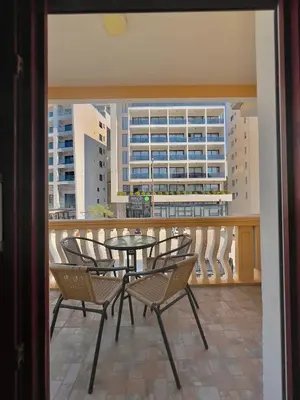 a balcony with a table and chairs and a view of a city at Apartments Albin in Ulcinj