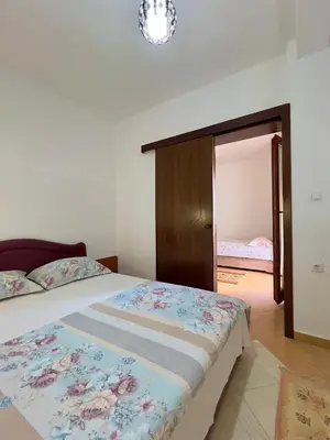 a bedroom with a bed and a mirror at Apartments Albin in Ulcinj