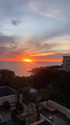 a view of the sunset from the balcony of a building at Apartments Albin in Ulcinj
