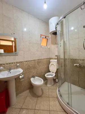 a bathroom with a toilet and a sink and a shower at Apartments Albin in Ulcinj