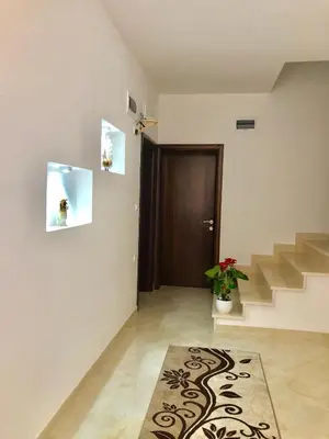 a living room with stairs and a rug on the floor at Apartments Albin in Ulcinj