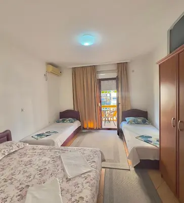 a hotel room with two beds and a window at Apartments Albin in Ulcinj