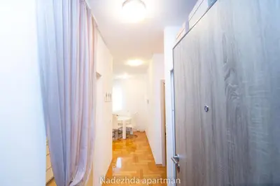 a hallway with a door and a table in a room at Marina Becici in Becici