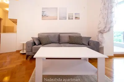 a living room with a couch and a table at Marina Becici in Becici