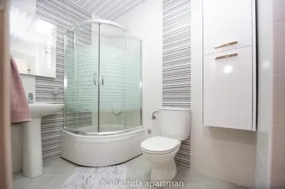 a bathroom with a toilet and a glass shower at Marina Becici in Becici