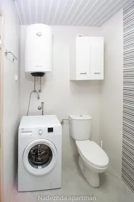a bathroom with a washing machine and a toilet at Marina Becici in Becici