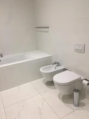 a white bathroom with a toilet and a sink at Sea View Villas in Duklei in Budva