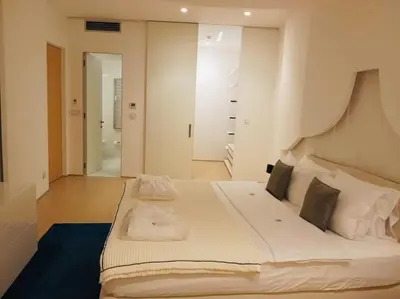 a bedroom with a large white bed with white pillows at Sea View Villas in Duklei in Budva