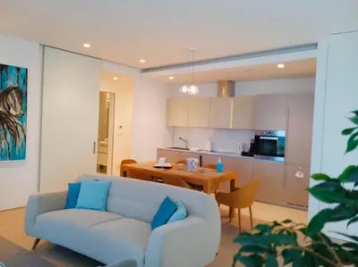 a living room with a blue couch and a kitchen at Sea View Villas in Duklei in Budva