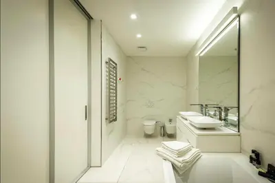 a white bathroom with a sink and a mirror at Sea View Villas in Duklei in Budva