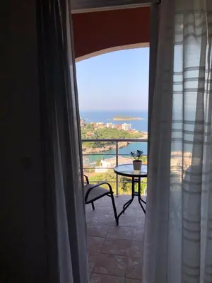 a room with a view of the ocean from a window at Open Sky Apartments in Utjeha