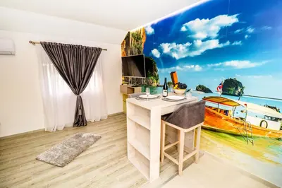 a room with a view of a boat on the wall at Simo apartments airport Podgorica in Podgorica