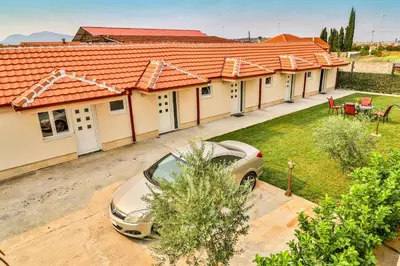 a car parked in front of a row of houses at Simo apartments airport Podgorica in Podgorica