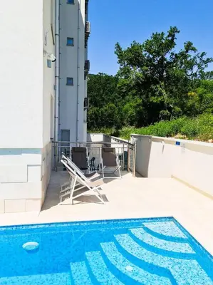 a swimming pool on the roof of a building at Garni Hotel Larimar in Budva