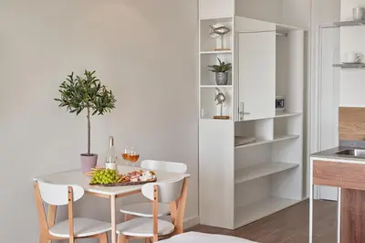 a kitchen and dining room with a table and chairs at Garni Hotel Larimar in Budva