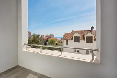 a balcony with a view of a building at Garni Hotel Larimar in Budva