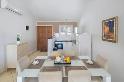 a kitchen and dining room with a table and chairs at Spa Resort Bečići in Budva