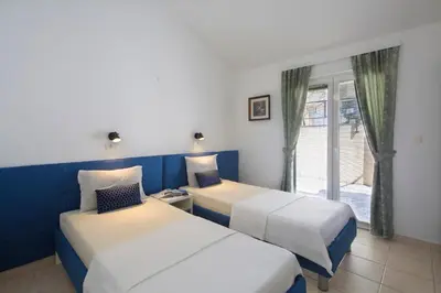 a hotel room with two beds and a window at Spa Resort Bečići in Budva