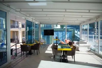 a living room with a table and chairs at Spa Resort Bečići in Budva