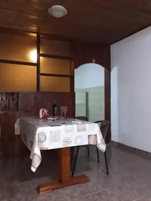 a table in a room with a white table cloth at Studio-apartman Milena 2 in Podgorica