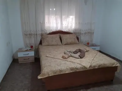 a child laying on a bed in a bedroom at Studio-apartman Milena 2 in Podgorica