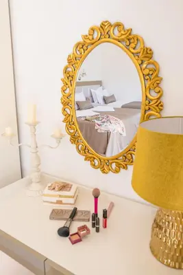 a dressing table with a mirror and a lamp at Villa Danigo in Budva