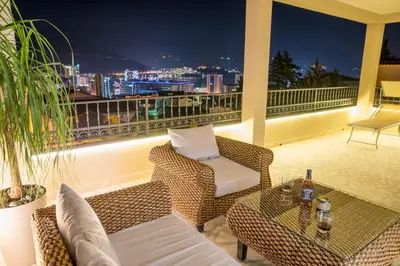 a balcony with a view of a city at night at Villa Danigo in Budva