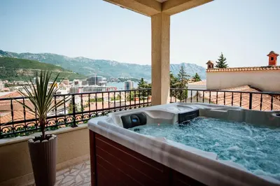 a hot tub on a balcony with a view at Villa Danigo in Budva