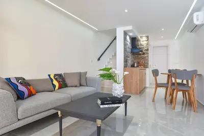 a living room with a couch and a table at Misisuone Apartments Budva in Budva