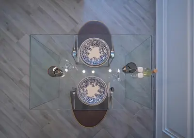 a glass table with plates on top of it at Misisuone Apartments Budva in Budva